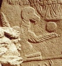 Close view of the bird on Pillar 43, its extended wing and the disc above it